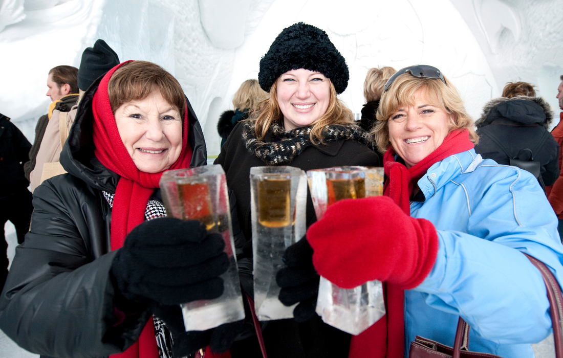 Three women sharing drinks in ice castle