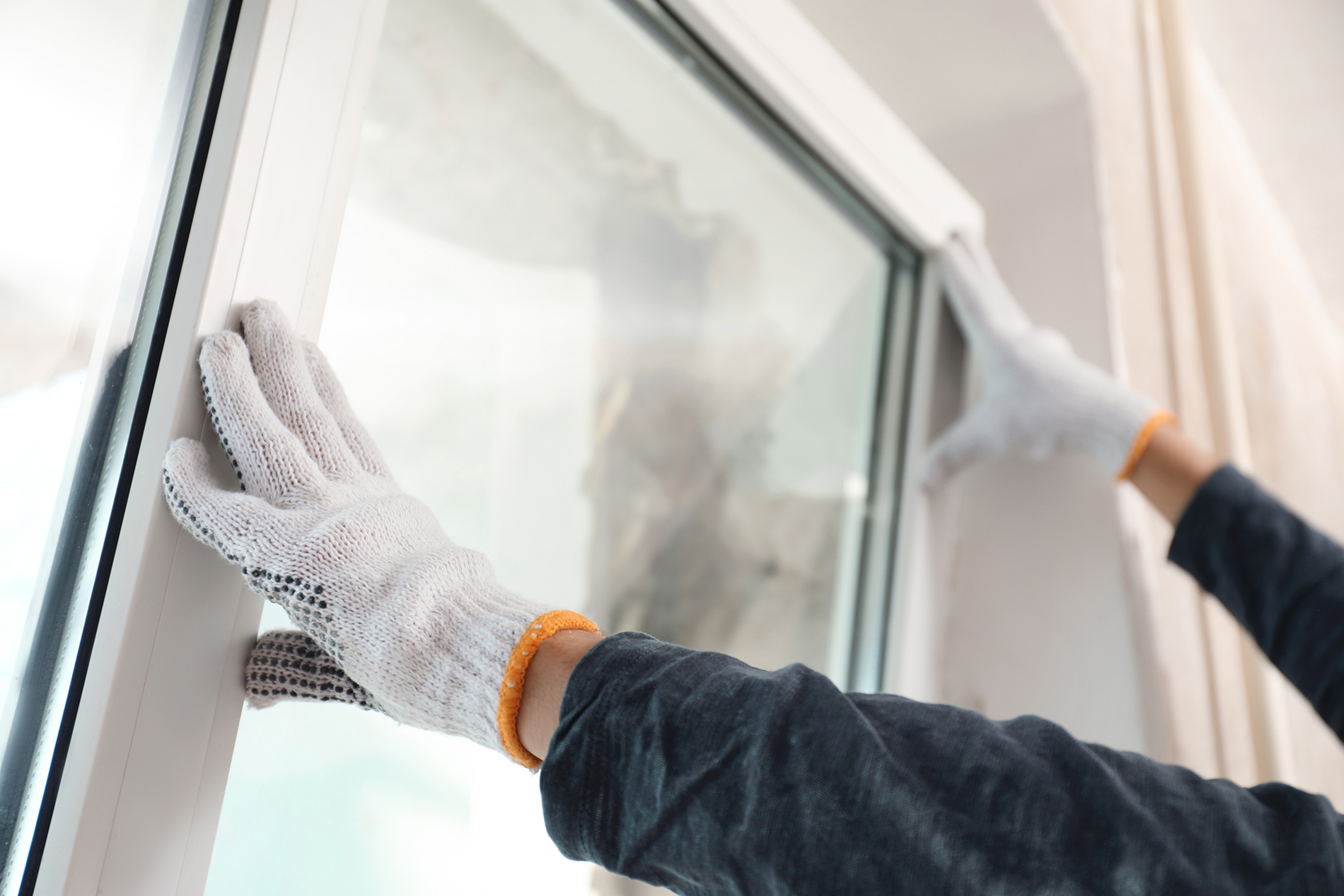 Window World employee installing energy-efficient windows, the best option for cold climates