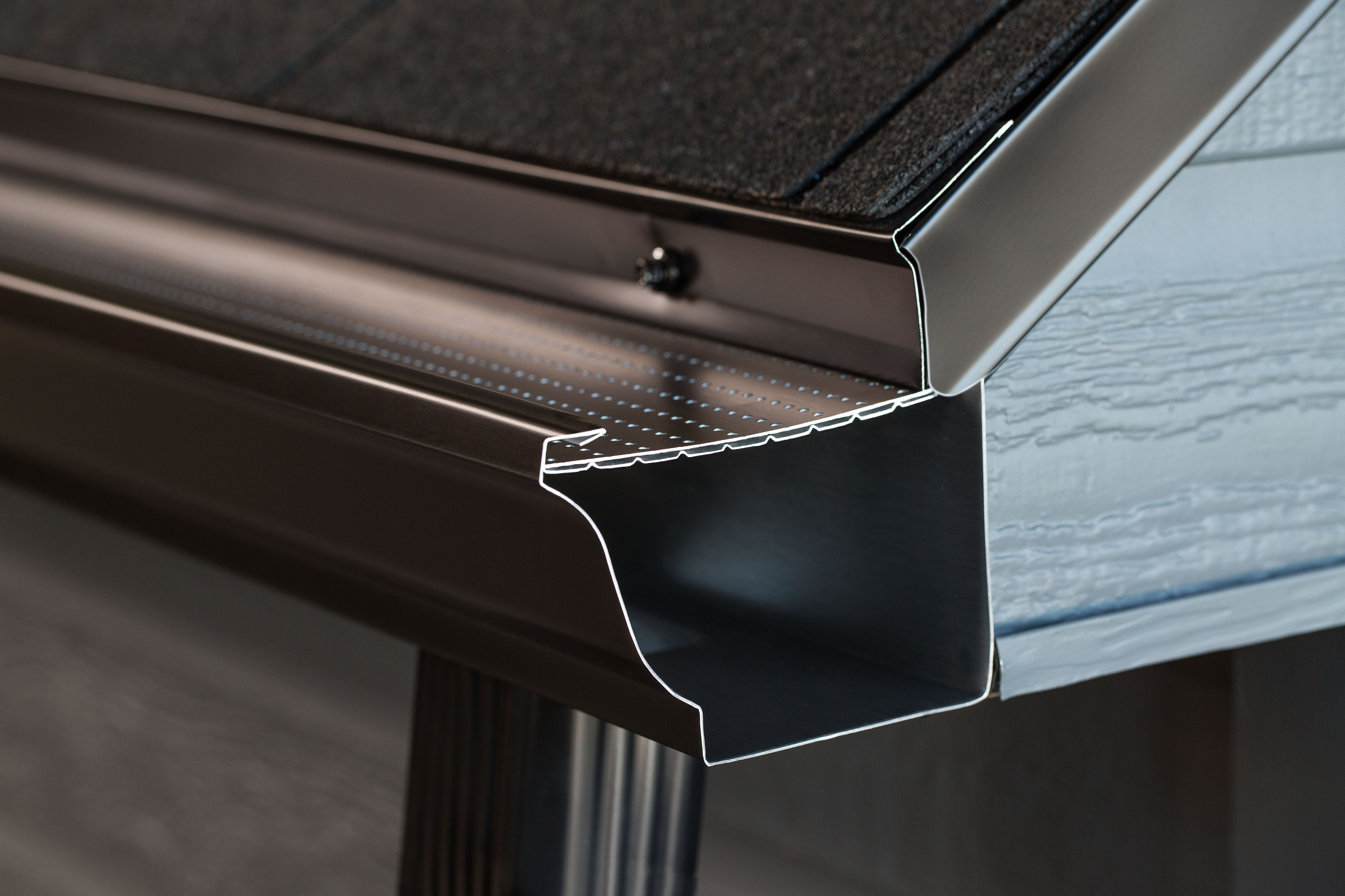 Leaf guard installed on gutter to prevent leaves and debris from clogging gutters.