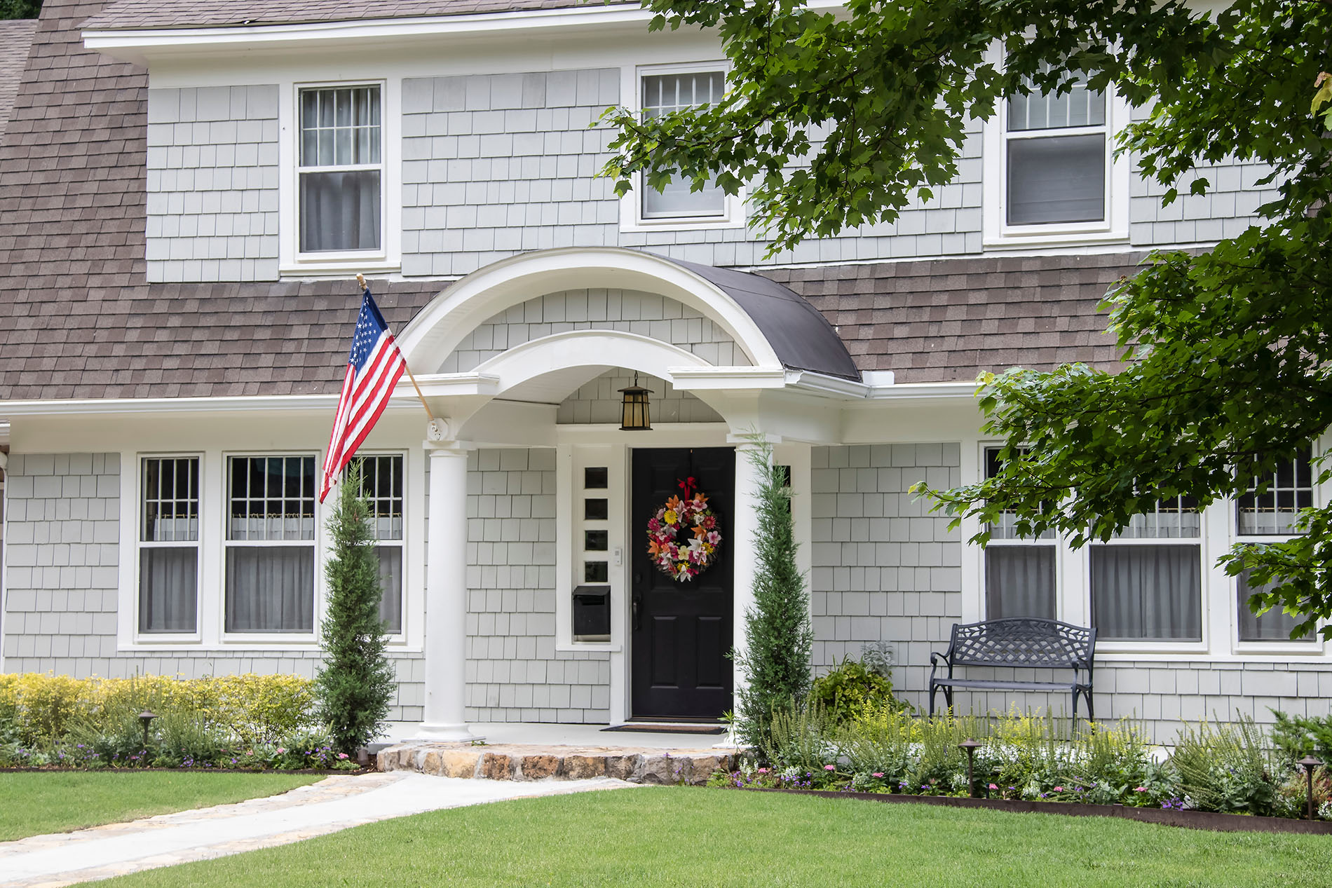 A house with a flag and wreath