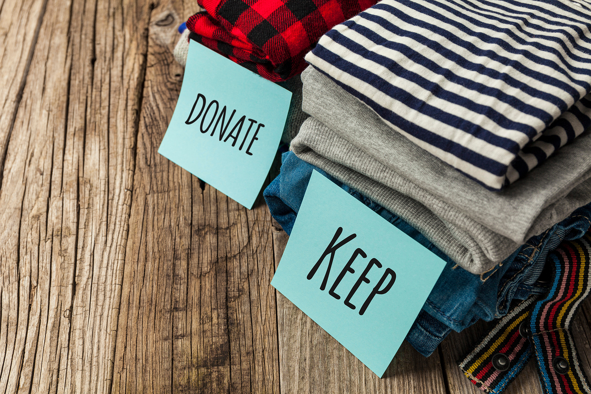 Folded clothes sorted into donate and keep piles