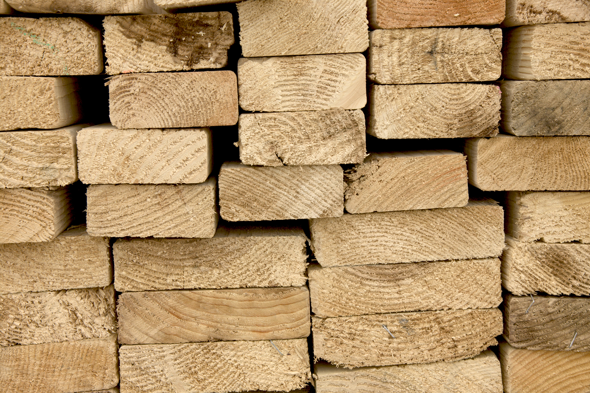 The ends of a stack of wood siding panels that need end-grain sealant.
