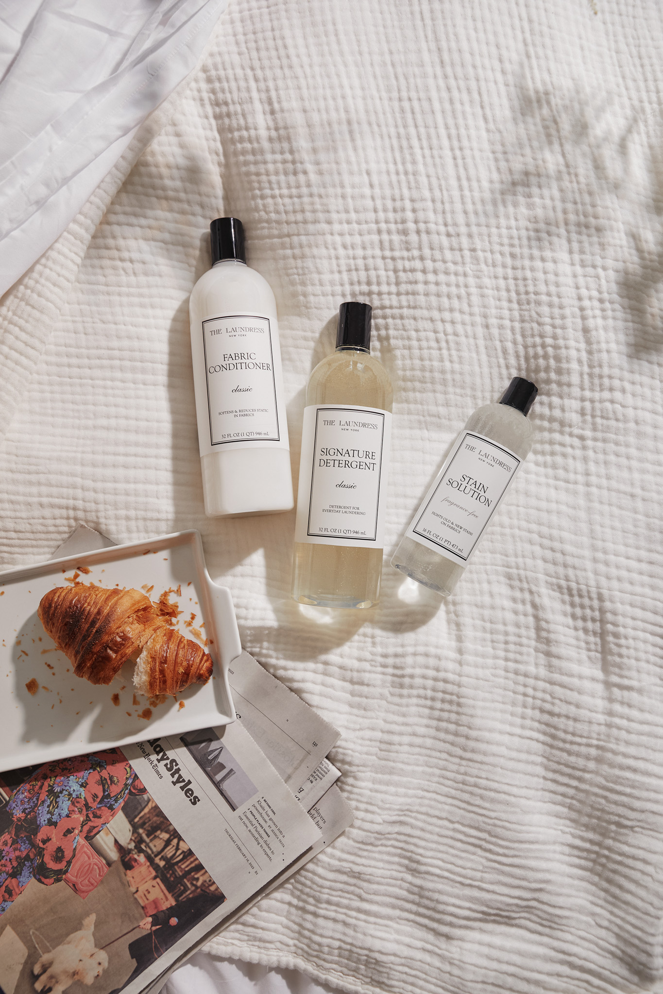 laundress products laying on bedding